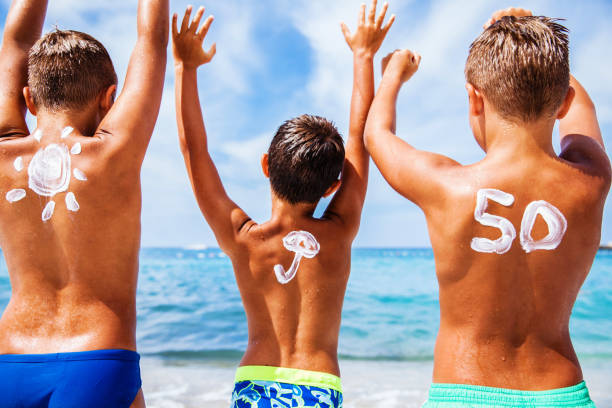istock Boys with sun protection on the beach 649034084