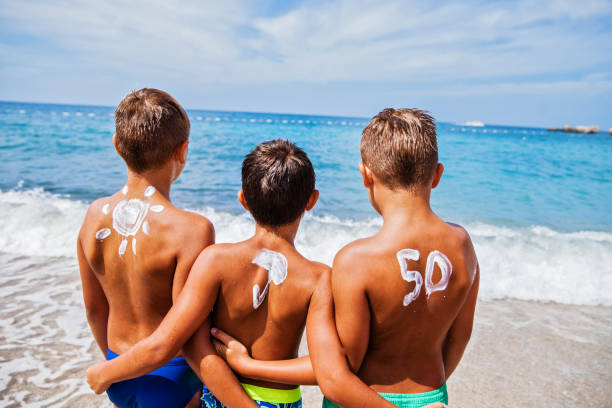 istock Boys with sun protection on the beach 649034118