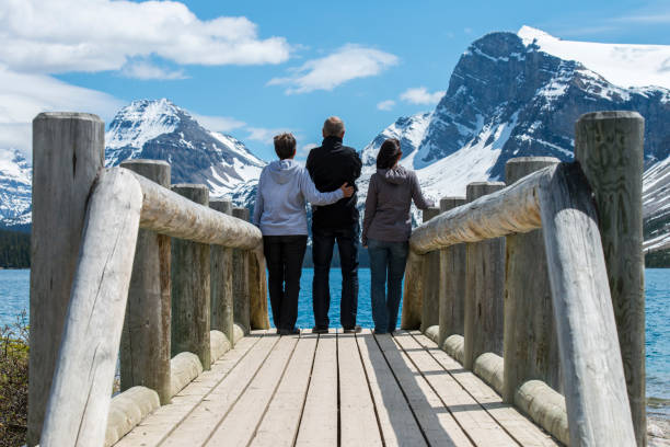 istock Parents and daughter look across mountain lake 649035865