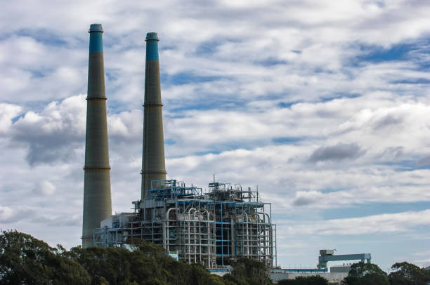 istock Power Plant Cooling Towers with Clouds in Background 649036712