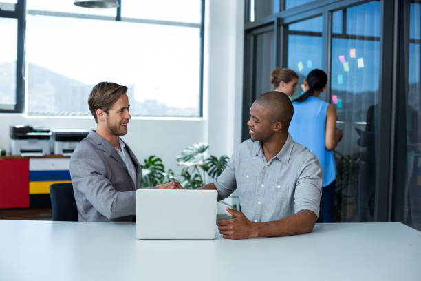 istock Businessman shaking hands with male executive 649037352
