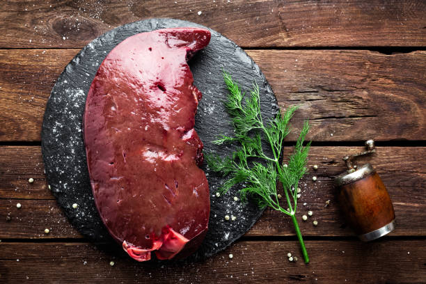 istock Raw liver on slate board on wooden background top view 649043456