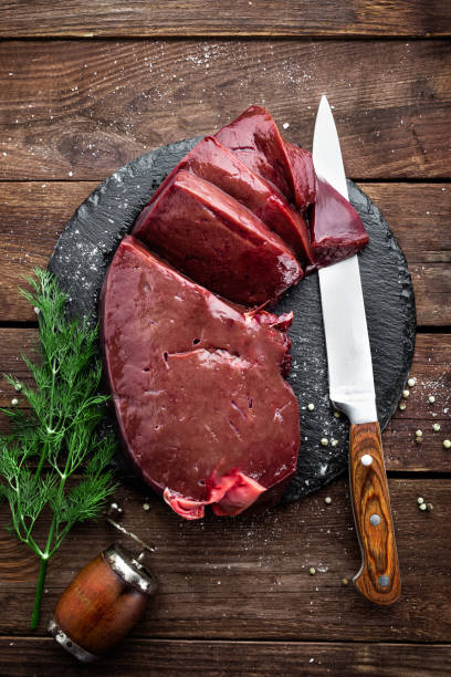 istock Raw liver on slate board on wooden background top view 649043522