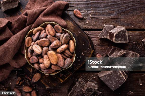 Cocoa Beans And Chocolate On Wooden Background Stock Photo - Download Image Now - Cocoa Bean, Dark Chocolate, Cacao Fruit