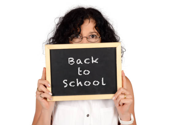 istock School teacher holding chalkboard with text 