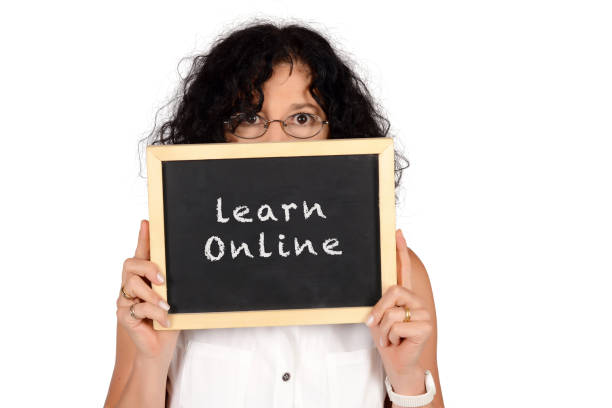 istock School teacher holding chalkboard with 