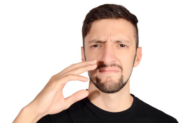 istock Man holding nose against bad smell. 649050740