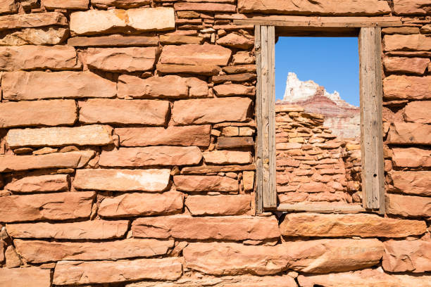 Small old window in a stone facade in a town in Spain.