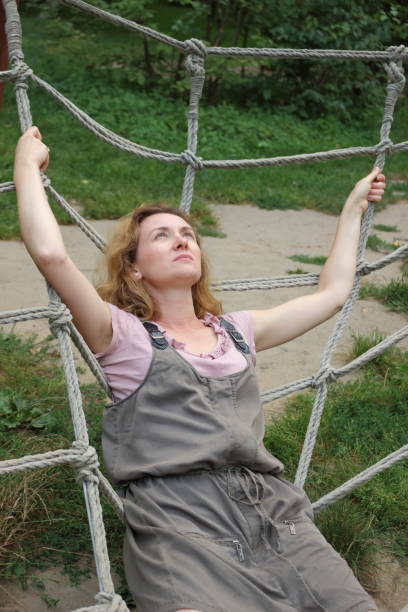 istock Woman laying on net maze. 649051476