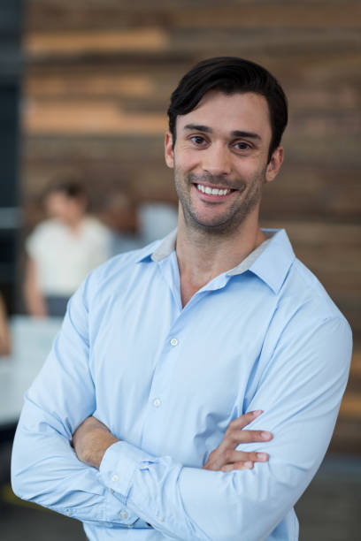 istock Business executive standing with arms crossed in office 649063738