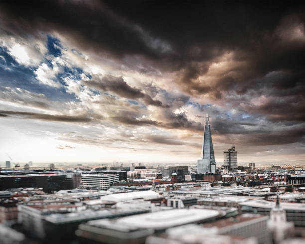 London, UK - 15 September, 2022: color image depicting the entrance to Borough Market - one of the oldest and most popular food markets in the UK - with The Shard rising up beyond, with a dazzling blue sky and cloudscape.
