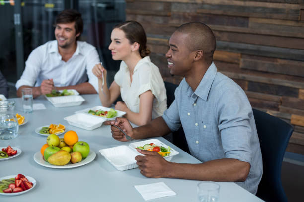 istock Smiling business executives having meal in office 649066842