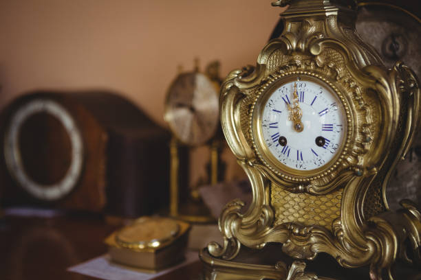 istock Close-up of golden watch on table 649073952