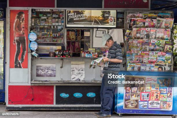 Belgrade Serbia August 2 2015 Old Man Reading A Newspaper At A Kiosk In Summer In The Capital City Of Serbia These Kiosks Are A Typical Part Of Balkan Urbanism Stock Photo - Download Image Now