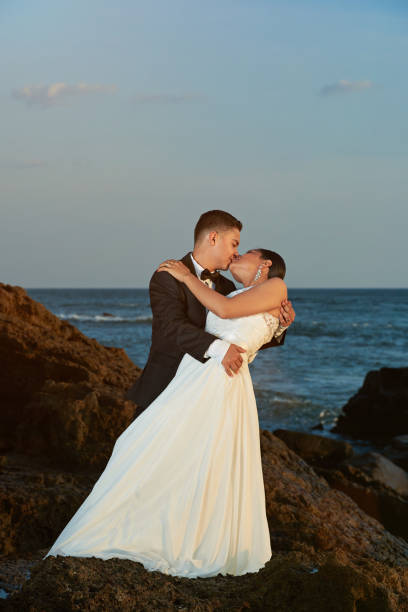 istock Bride and groom kissing on sunset light 649074854