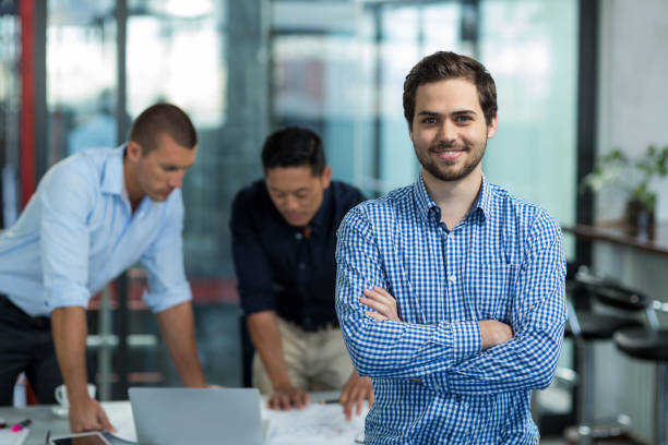istock Business executive standing with arms crossed in office 649078892