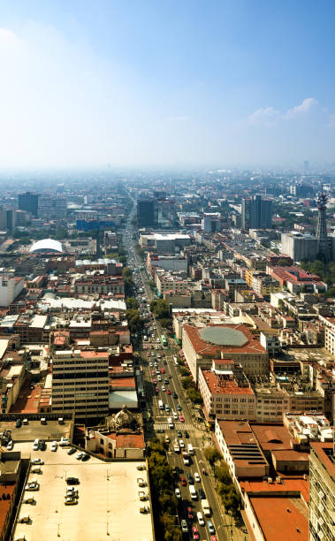 Eje Central Lazaro Cardenas, street full of cars in Mexico City, capitol of Mexico, on a sunny morning with haze.