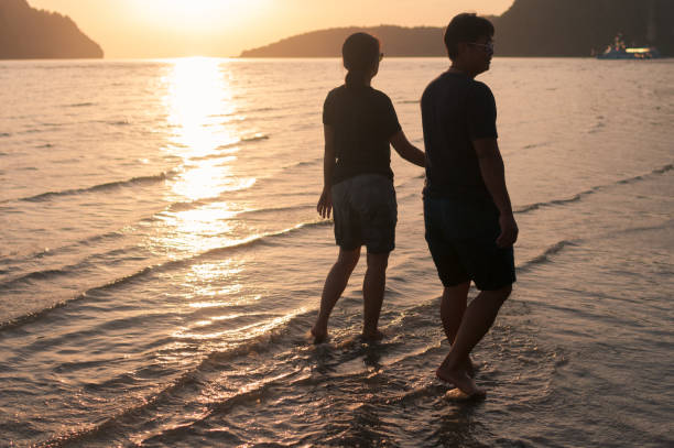 istock happy family walking on the beach 649090312