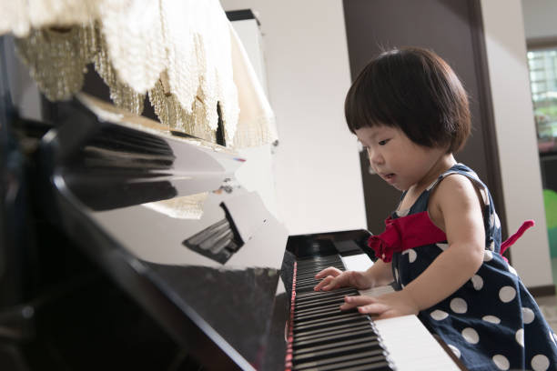 istock Little Asian child at piano 649090924