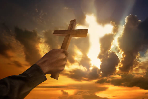 istock Man hand holding wood cross or religion symbol shape 649091636