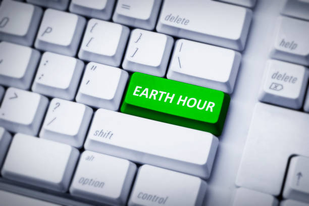 istock Earth hour on green and white keyboard button 649101668