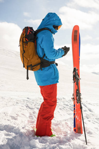 istock Skier using mobile phone on the snowy mountains 649101782