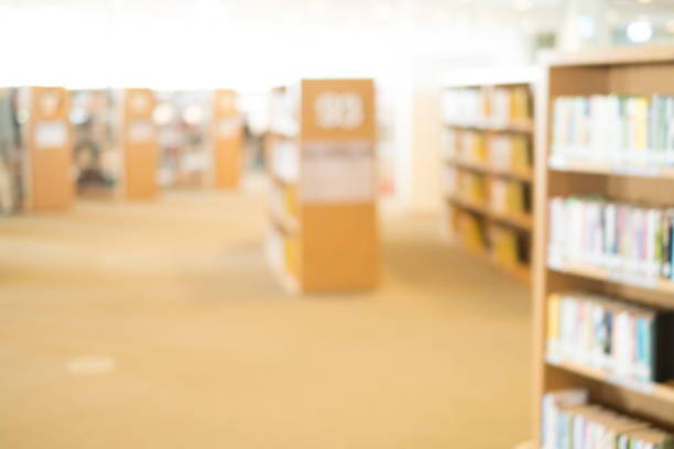 istock books on bookshelf in library, abstract blur defocused background 649104768