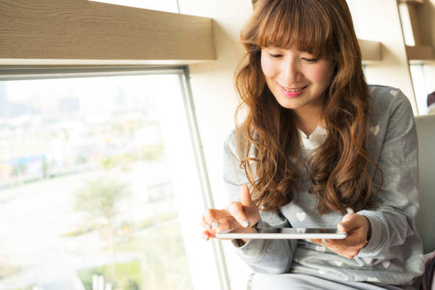 istock Asian young woman use of tablet pc 649104858