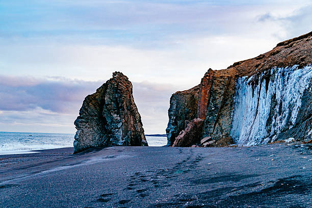 istock Rock Formations At Beach Against Cloudy Sky 649107127