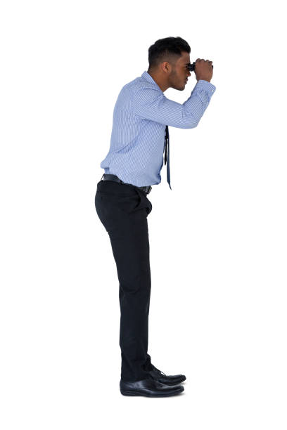 istock Businessman looking through binoculars against a white background 649110940