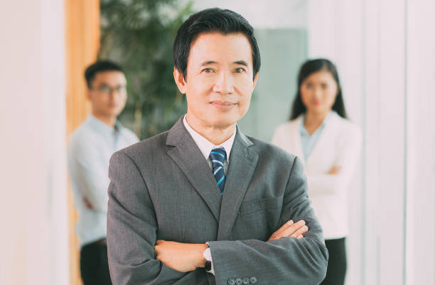 istock Confident senior Asian businessman with his team 649121666