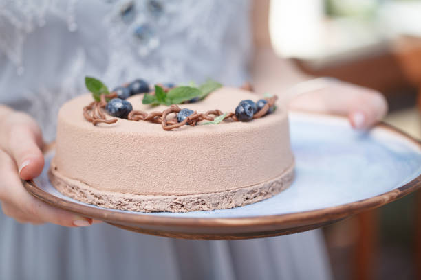 istock hands holding delicious creamy cake 649122262