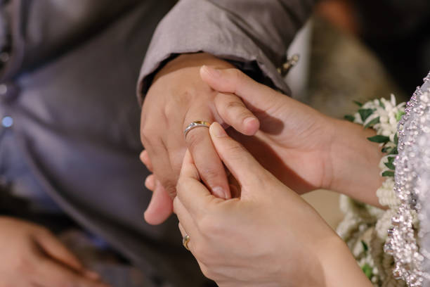 istock Hand of lover are wearing a ring on her wedding day 649129236
