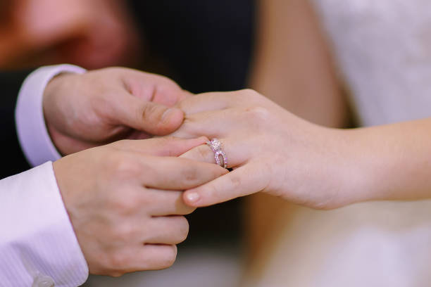 istock Hand of lover are wearing a ring on her wedding day 649129272