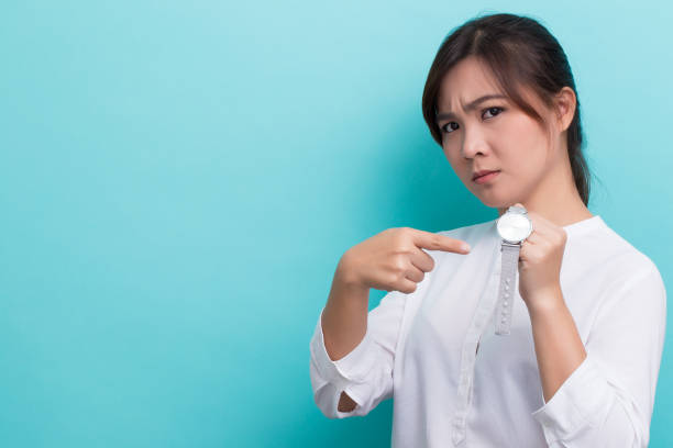 asian woman ask "what time is it" - waiting women clock boredom imagens e fotografias de stock