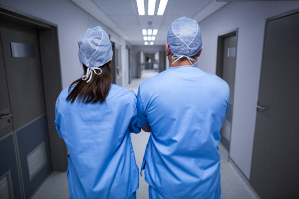 istock Surgeons standing in hospital corridor 649129746