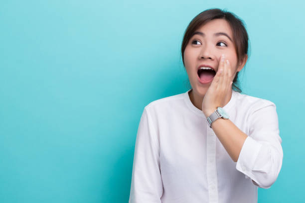 istock Asian woman make gossip gesture 649132596