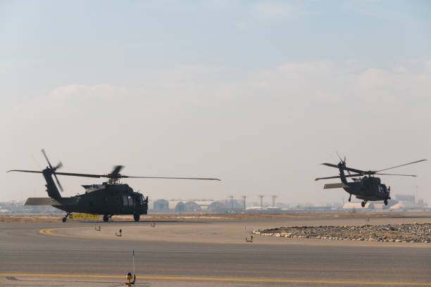 istock Two Military utility helicopters taking off at dusk 649145384