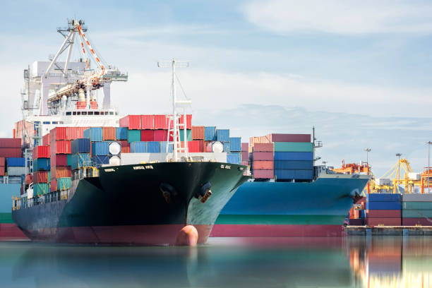 istock International Container Cargo ship with working crane bridge in shipyard background, logistic import export background and transport industry. 649148036