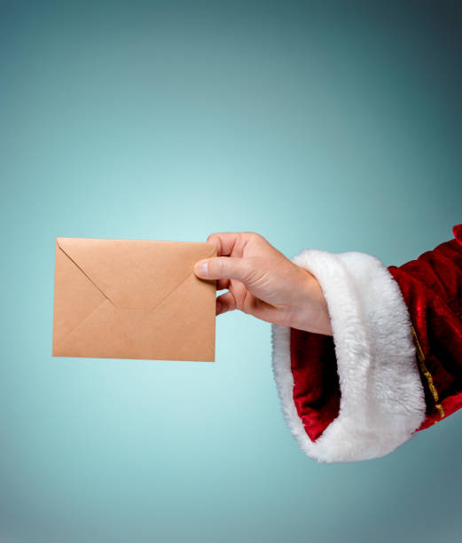 istock Hand in costume Santa Claus is holding the envelope 649152782