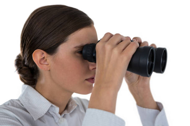 istock Businesswoman looking through binoculars against a white background 649156078