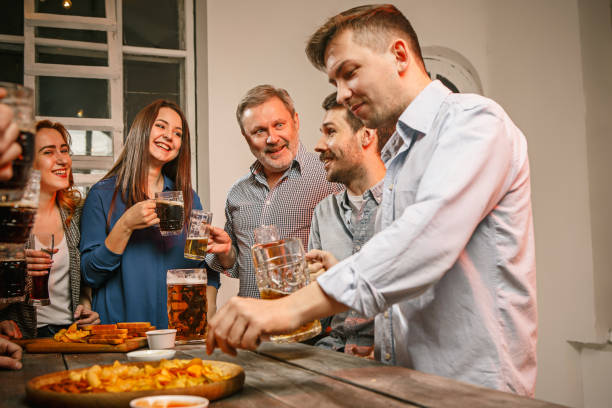 istock Group of friends enjoying evening drinks with beer 649159906