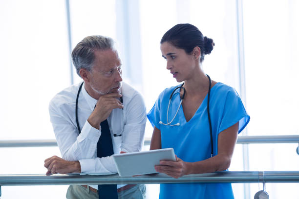 istock Doctor and colleague discussing over digital tablet 649163976