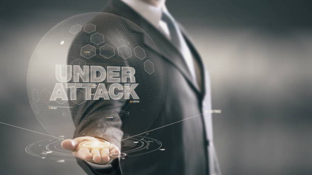 under attack businessman holding in hand nuove tecnologie - under attack foto e immagini stock