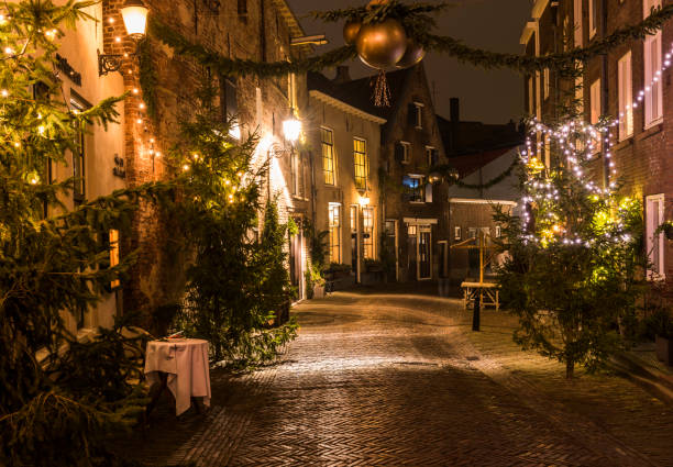Dickens Festival Roggestraat Xmas Deventer, The Netherlands - December 17, 2016: Roggestraat (street) in Deventer during Christmas time in the evening with christmas lights and  lanterns during Dickens Festival. deventer photos stock pictures, royalty-free photos & images
