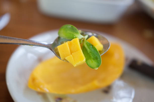 istock closeup of fresh mango cubes on spoon 649168290