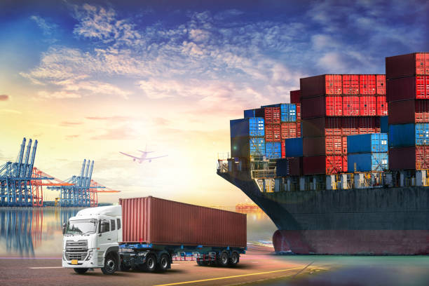 istock Logistics import export background and transport industry of Container truck and Cargo ship with working crane bridge in shipyard at sunset sky 649172002