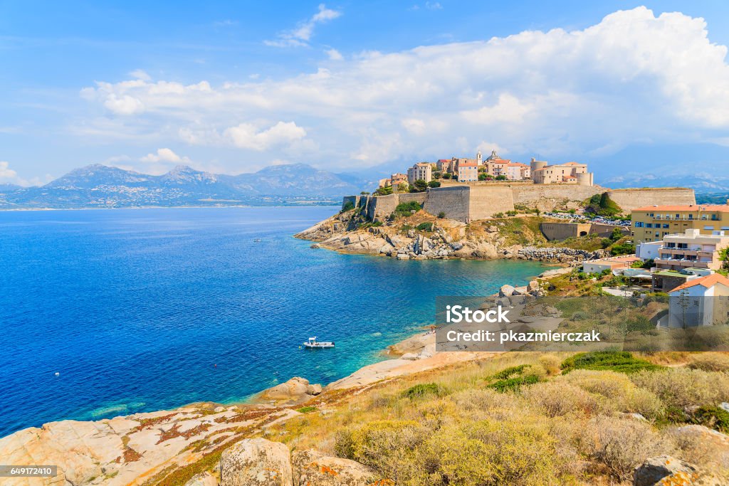 View of citadel with houses in Calvi bay, Corsica island, France. Corsica is the largest French island on Mediterranean Sea and most popular holiday destination for French people. Calvi Stock Photo