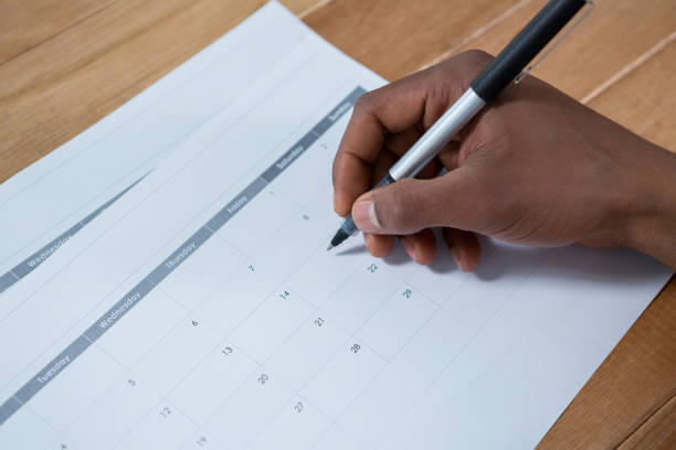 istock Businessman marking with pen on calendar 649175116