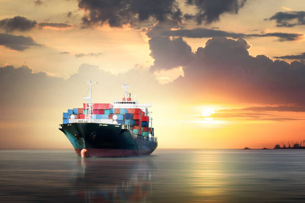 istock International Container Cargo ship in the ocean as sunset sky, Freight Transportation, Shipping 649176404